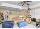 Open game room with multiple seating areas, a projector, and classic arcade games, designed for relaxation and fun at 1065 Cavan Dr, Apopka, FL 32703