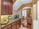 Detailed kitchen with granite counters, a coffee station, and dark wood cabinetry at 1065 Cavan Dr, Apopka, FL 32703