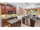 Charming kitchen featuring granite countertops, stainless appliances, and an island for food prep at 1065 Cavan Dr, Apopka, FL 32703