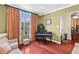 Relaxing living room with hardwood floors, a piano, and a view to the entryway at 1065 Cavan Dr, Apopka, FL 32703