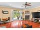 Bright living room with hardwood floors and fireplace offers seamless indoor/outdoor living at 1065 Cavan Dr, Apopka, FL 32703