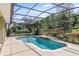 Inviting screened-in pool with tranquil waterfall feature offers a private backyard oasis at 1065 Cavan Dr, Apopka, FL 32703