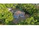 Aerial view of the home showing roof, yard, and surrounding wooded landscape at 1150 Virginia Avenue, Altamonte Springs, FL 32701