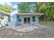 Cozy back patio with stone pavers, sliding glass door and fireplace offering a private outdoor space at 1150 Virginia Avenue, Altamonte Springs, FL 32701