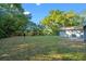 Spacious backyard featuring mature trees, grassy area, and partial fence, perfect for outdoor activities and entertaining at 1150 Virginia Avenue, Altamonte Springs, FL 32701