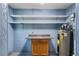 Basement or storage space with blue walls, storage cabinets, shelving, and a hot water tank at 1150 Virginia Avenue, Altamonte Springs, FL 32701