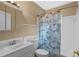 Bathroom featuring a sink, toilet, tub with shower with a floral curtain, and vanity mirror at 1150 Virginia Avenue, Altamonte Springs, FL 32701