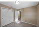 Bedroom with double door closet and doorway with bright light and neutral finishes at 1150 Virginia Avenue, Altamonte Springs, FL 32701
