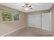 Bedroom featuring a ceiling fan, window view, and a large closet with white doors at 1150 Virginia Avenue, Altamonte Springs, FL 32701
