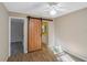 Bedroom with a modern ceiling fan and wood-look flooring, enhanced by a sliding barn door at 1150 Virginia Avenue, Altamonte Springs, FL 32701