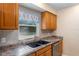 Lovely kitchen sink area with wooden cabinets and window letting in plenty of light at 1150 Virginia Avenue, Altamonte Springs, FL 32701