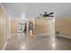 Spacious living room with ample lighting and ceiling fan fixture overlooking kitchen area and fireplace at 1150 Virginia Avenue, Altamonte Springs, FL 32701