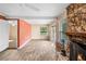 Open-concept living room with a stone fireplace, tile floors, and sliding glass doors at 1150 Virginia Avenue, Altamonte Springs, FL 32701
