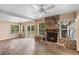 Spacious living room featuring a stone fireplace and views of the backyard at 1150 Virginia Avenue, Altamonte Springs, FL 32701
