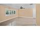 Empty living room with a ceiling fan, neutral walls, and shuttered windows at 1150 Virginia Avenue, Altamonte Springs, FL 32701