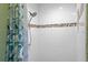 Tiled walk-in shower featuring white subway tiles, accent border, and modern showerhead fixture at 1150 Virginia Avenue, Altamonte Springs, FL 32701