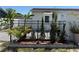 Charming backyard with a brick-lined garden bed, complemented by lush greenery and an inviting outdoor seating area at 1180 Baton Dr, Deltona, FL 32725