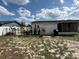 Spacious backyard with a patio, black fence, and exterior of home at 1180 Baton Dr, Deltona, FL 32725