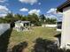 Large backyard featuring a sitting area with pergola, shed, and a well maintained lawn at 1180 Baton Dr, Deltona, FL 32725