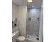Modern bathroom showcasing a glass enclosed shower with stylish marble-look tile at 1180 Baton Dr, Deltona, FL 32725