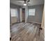 Bedroom featuring wood-look floors, closet and exterior door at 1180 Baton Dr, Deltona, FL 32725