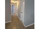 Hallway showcasing tile flooring, neutral paint, and multiple doorways to various rooms at 1180 Baton Dr, Deltona, FL 32725