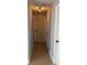 Hallway featuring tile flooring, neutral walls, and a modern light fixture at 1180 Baton Dr, Deltona, FL 32725