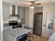 Well-equipped kitchen features stainless steel appliances, granite countertops, and ample cabinet space at 1180 Baton Dr, Deltona, FL 32725