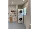 Functional laundry room equipped with a stacked washer and dryer for added convenience at 1180 Baton Dr, Deltona, FL 32725