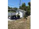 Outdoor shed with a seating area and pergola in the backyard at 1180 Baton Dr, Deltona, FL 32725