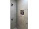 Close-up of a modern shower with sleek hardware and built-in shelving, complete with marble-look tiles at 1180 Baton Dr, Deltona, FL 32725
