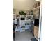 Organized storage room with shelves, small refrigerator, microwave and tiled floor at 1180 Baton Dr, Deltona, FL 32725