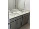 Bathroom featuring a double sink vanity with granite countertop and gray cabinets at 1235 Island Slough Ln, Davenport, FL 33837