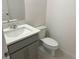 Cozy half bathroom with a modern vanity, sink, and toilet at 1235 Island Slough Ln, Davenport, FL 33837