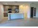 Open concept kitchen with center island and stainless steel appliances, adjacent to a dining area at 1235 Island Slough Ln, Davenport, FL 33837