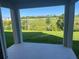 Outdoor patio overlooking landscaped yard with lush green grass and trees at 1235 Island Slough Ln, Davenport, FL 33837