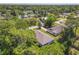 Aerial view of a house in a wooded neighborhood showcasing the roof and surrounding greenery at 1314 Victory Palm Dr, Edgewater, FL 32132