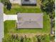 An aerial view of a home featuring a well-maintained roof, driveway, and lush landscaping at 1314 Victory Palm Dr, Edgewater, FL 32132