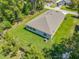 Aerial view of house with a large, well-maintained lawn and mature trees surrounding the property at 1314 Victory Palm Dr, Edgewater, FL 32132