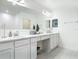 Bathroom with white cabinetry, dual sinks and vanity, with tile flooring and modern lighting at 1314 Victory Palm Dr, Edgewater, FL 32132