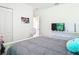 Bright bedroom features an off-white color scheme and includes a fan and tv on a dresser at 1314 Victory Palm Dr, Edgewater, FL 32132