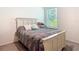 Cozy bedroom with a decorative headboard and window showcasing outdoor views at 1314 Victory Palm Dr, Edgewater, FL 32132