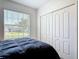 Bedroom featuring a window with natural light, double door closet, and carpet flooring at 1314 Victory Palm Dr, Edgewater, FL 32132