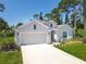 Charming one-story home with a two-car garage, long driveway, and meticulously manicured landscaping at 1314 Victory Palm Dr, Edgewater, FL 32132