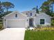Attractive single-story home with well-kept lawn, two-car garage and modern architectural details at 1314 Victory Palm Dr, Edgewater, FL 32132