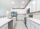 Bright kitchen features white cabinets, stainless steel appliances, and a spacious countertop at 1314 Victory Palm Dr, Edgewater, FL 32132
