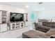 Open-concept living room with tile flooring, TV, and dining area at 1314 Victory Palm Dr, Edgewater, FL 32132