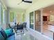 Bright sunroom features large windows and a sliding glass door that leads to the living room at 1314 Victory Palm Dr, Edgewater, FL 32132