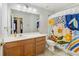 Bathroom with a flowered curtain over the shower/tub and a wood cabinet sink at 1354 Riley Cir, Deland, FL 32724
