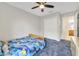 Bright bedroom boasts plush carpeting, ceiling fan, closet and adjacent bathroom at 1354 Riley Cir, Deland, FL 32724
